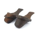 A pair of children’s horse-riding slipper stirrups, in hand-stitched leather and metal, likely 18th