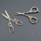 Antique scissors: a pretty pair of silver embossed metal needlework scissors with cherubs sitting ju