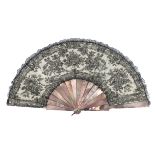 A third quarter 19th century black Chantilly lace fan, the lace with a backing of cream silk, the mo