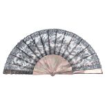 A third quarter 19th century black Chantilly lace fan, the leaf of floral design, mounted on dusky T