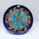 A Longwy style charger, faience decoration depicti