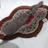 A tribal paddle, handle carved as a figure, together with a beaded tray, framed on bun feet (2)