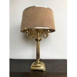 A decorative brass four light library table lamp, circa 1980's, tan suede effect shade, fluted