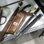 Selection of weapons, a kukri blade in a wooden sc