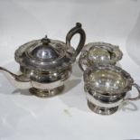 A plated three piece circular tea set, with foliate mounts, together with assorted plated flatware