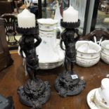 A pair of metal cherub candle holders