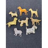 A selection of eight dog brooches, to include two enamel examples, one stamped silver, four