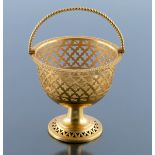 A reticulated gilt pedestal basket