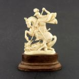 An antique carved ivory model of St George and the