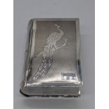 An Eastern silver snuff box in the form of a book, depicting a Peacock, vacant cartouche, 203g, L.