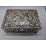 A large 19th century Continental silver box, decorated with a cherub scene and side panels of leaves