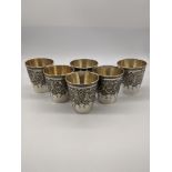 A set of 6 Persian silver beakers, etching with flora and fauna decoration, marks to bases, 562g,