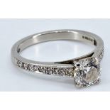 An impressive diamond and platinum engagement ring, central round brilliant cut diamond (approx. 1.