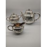 A Japanese silver tea set, embossed with floral designs, stamped Sterling to base, 952g, H.14cm