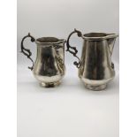 Two unusual South American silver jugs, one with cherub applique, unmarked, the larger with