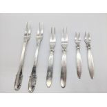 Six Georg Jensen Danish silver condiment forks, 87g, L.13.5cm (longest)