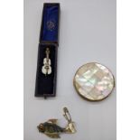 A mother of pearl violin brooch, mother of pearl compact and a fish brooch
