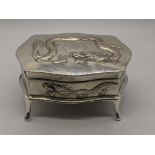 A Chinese silver jewellery casket decorated with dragon, raised on four feet, H.7.5cm L.10.5cm