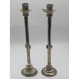 An unusual pair of Middle Eastern candlesticks, mounted with Roman glass, inscription to base,