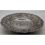 An early 20th century Egyptian silver dish, repousse embossed, raised on three feet, 198g D.20cm