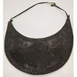 A 19th century or earlier Persian Islamic embossed leather pectoral ornament (Gorget) for a soldier,
