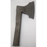 An Eastern axe, cast metal with scrolling decoration, L.31cm