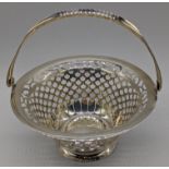 An early 20th century silver basket, pierced body with swing handle, hallmarked Birmingham, 1903,