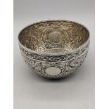 A late Victorian silver bowl, embossed with birds and stylised flowers