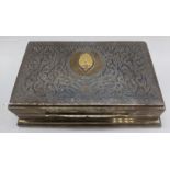 A Thai silver cigar box, stylised decoration with central gold coloured medallion, burr walnut