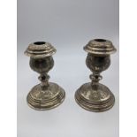 A pair of Persian silver candlesticks, engraved decoration, marked, 668g, weighted bases, H.12cm