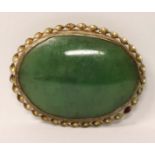 Jade and gold filled brooch, H.4cm