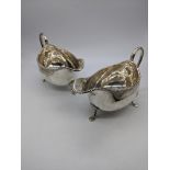 A pair of George V silver sauceboats, beaded edge, raised on three stepped feet, hallmarked