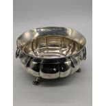 A Continental silver twin handled dish, raised on 3 paw feet, indistinct marks, engraving to base,
