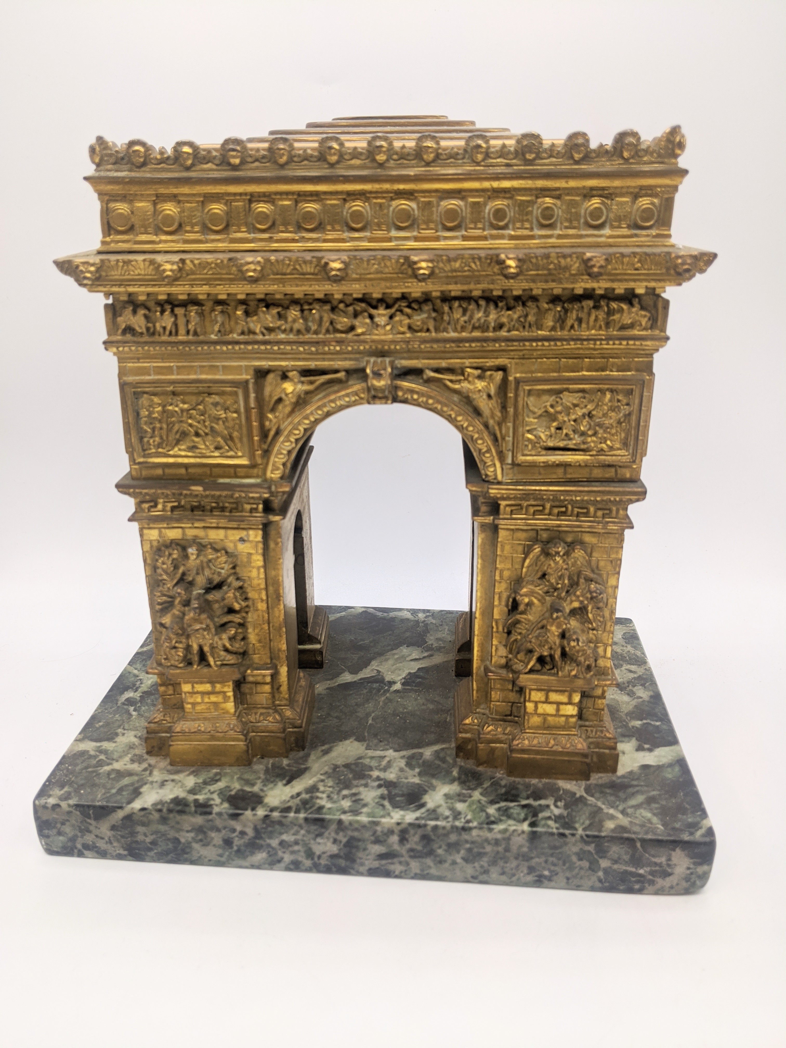 An ormolu bronze model of the Arc de Triomph, mounted on a marble base, circa 1900, H.21cm W.19cm