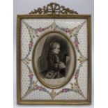 A late 19th/ 20th century Russian enamelled photo frame with an engraving of Mozart at the age of