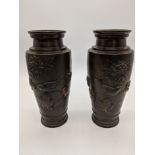 A pair of Japanese bronze and brass vases depicting birds amongst blossoming chrysanthemums,