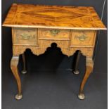 A Georgian mahogany lowboy, deep shaped drawers over a shaped apron, raised on cabriole legs and pad