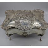 An Edwardian silver jewellery casket by Williams Comyns & Sons, embossed figural scene to lid,