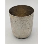 A German silver beaker, planished finish, marks to base, 90g, H.7cm