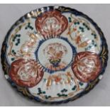 A 19th century Japanese porcelain charger, figural and floral scenes, blue and white pattern to