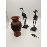 A pair of Japanese bronze storks on turtles together with a red ground vase depicting a dragon, H.