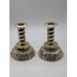 A pair of Victorian silver candlesticks, embossed bases, pie crust edges, hallmarked to inserts