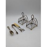 A pair of silver toast racks, hallmarked Birmingham, H.11cm, together silver a silver scoop,