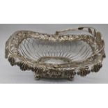 An early 19th century Russian silver basket, decorated with feather and roses border, raised on four