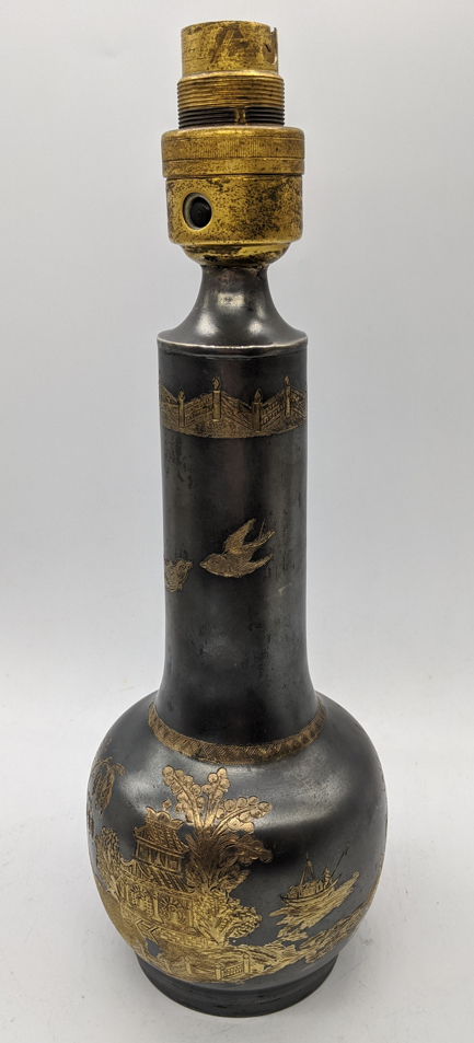 An early 20th century silver lamp, etched with Chinese garden scenes, marked to base for London,