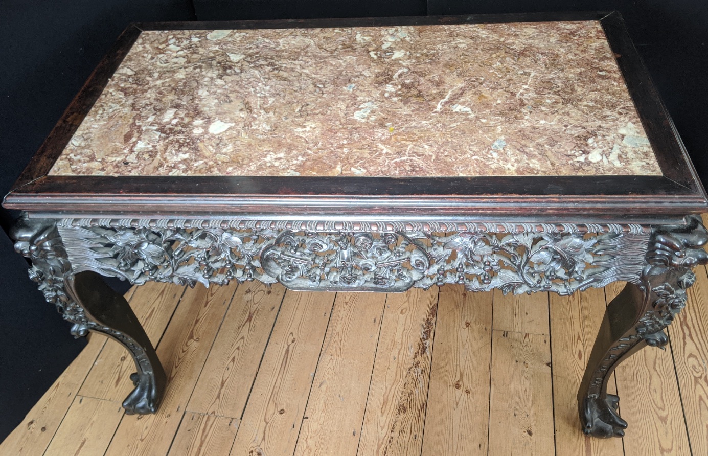 A late 19th century Chinese carved hardwood table, marble top, pierced frieze with figural scenes,