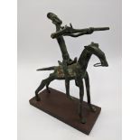 A West African tribal bronze of a horseback rider firing a musket, Dogon or Senufo, raised on