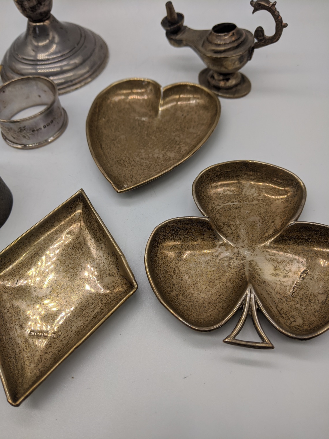 A collection of silver items to include a Reed & Barton candlestick, diamond heart and clubs dishes, - Image 4 of 4