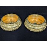 A large pair of Victorian silver gilt coasters, central silver appliques with crest of hand with