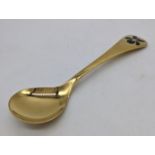 A Georg Jensen gilt silver annual 1977 spoon, violet enamel flower to terminal, Danish marks, 43g,